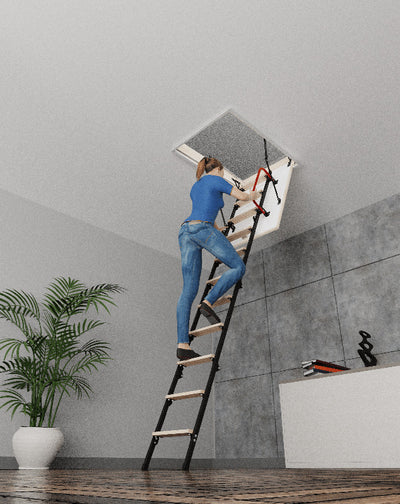 Woman climbing up on the 31.5 x 31.5 attic ladder with handrail on tle left side